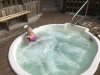 Kathy having a Bloody Mary in the hot tub overlooking Canoe Pass