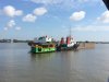 That's our boat tied up to the barge waiting for us....Mama IV