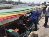 Kathy getting in our long-tail boat for a canal tour