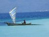 Fisherman in his outrigger sailing home