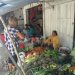 Kathy buying a pineapple