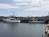 Mystic next to a local fishing boat
