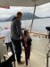 Dave teaching Kennedy to reel in a salmon; John ready to net!!