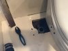 The toilet discharge hose next to the toilet