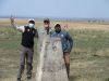 Paul, John and Jacob at a border marking the line between Tanzania and Kenya