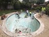 Breaking up and taking out old plaster, tile and coping